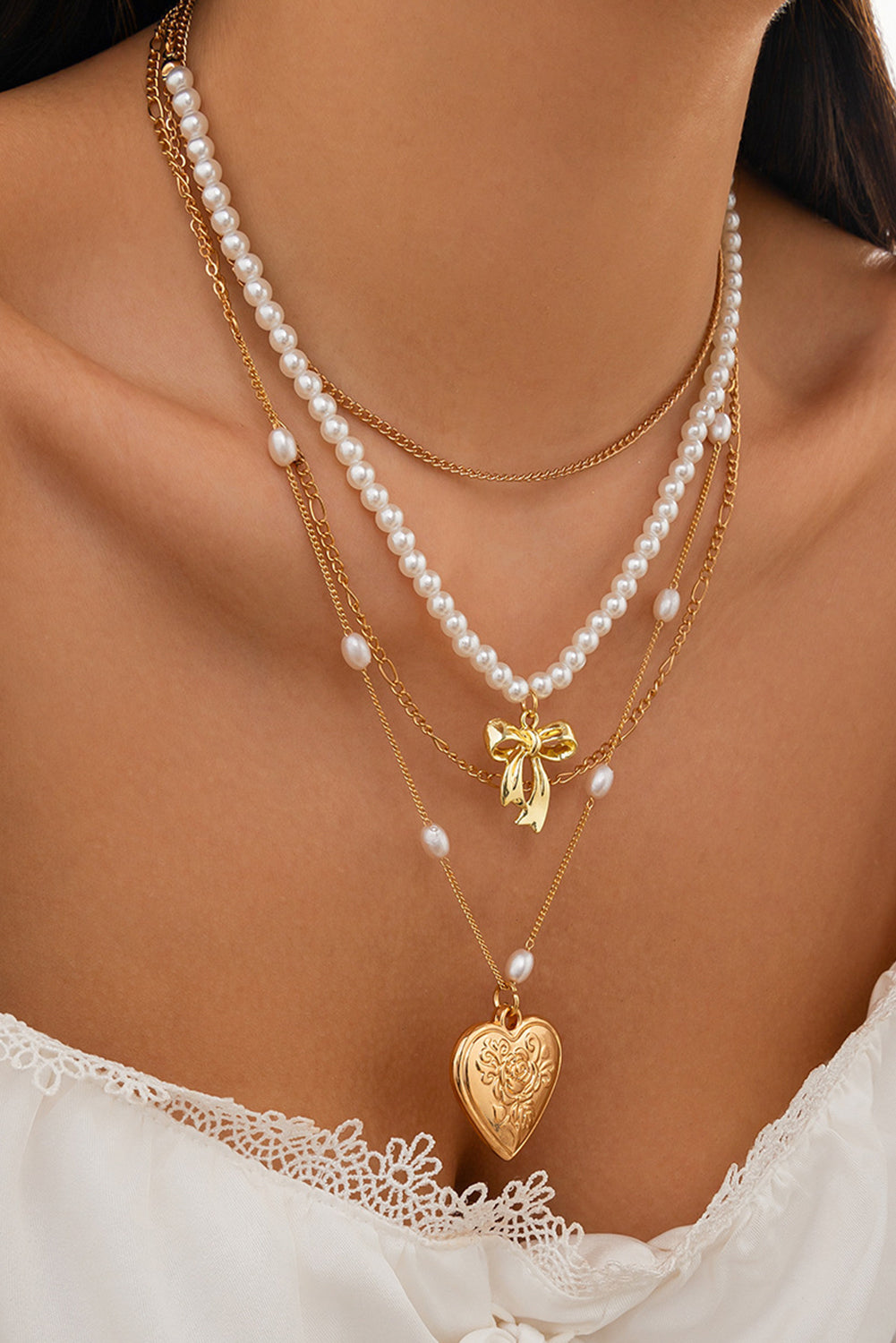 Multi-layer necklace with gold heart pendant and pearls