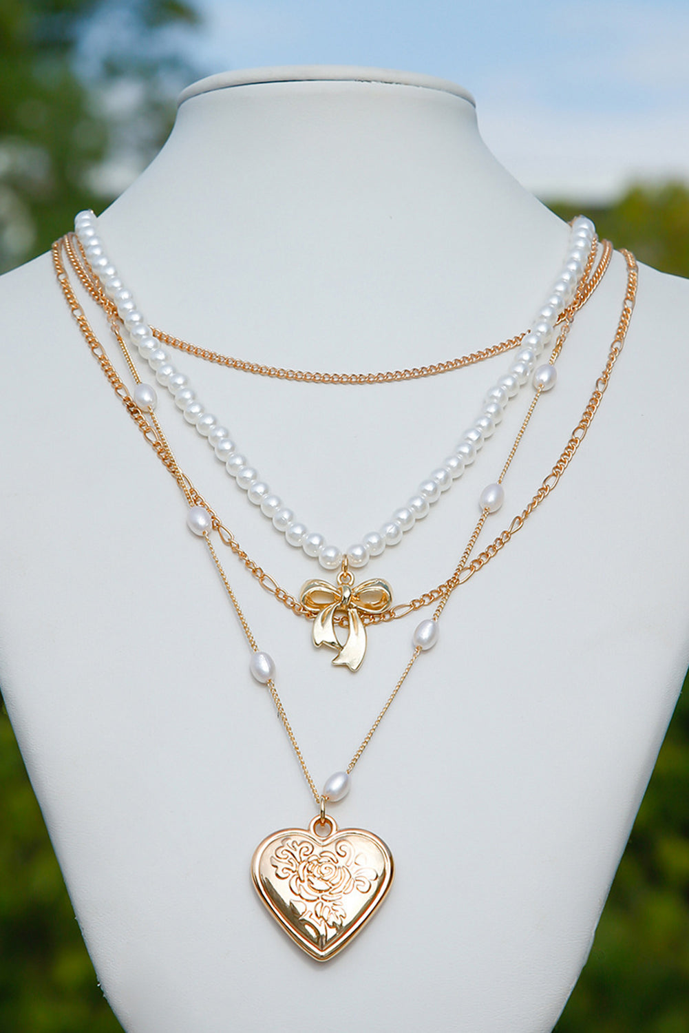 Multi-layer necklace with gold heart pendant and pearls