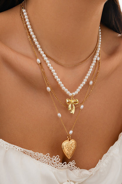 Multi-layer necklace with gold heart pendant and pearls